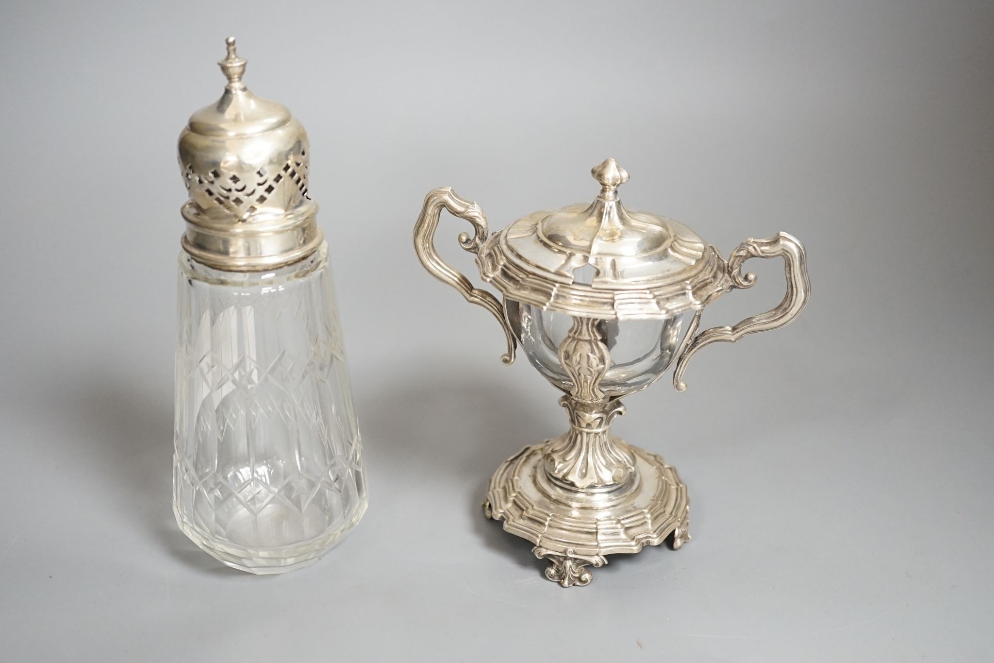 A George V silver mounted glass caster and a continental silver mustard pot frame (the latter a.f)